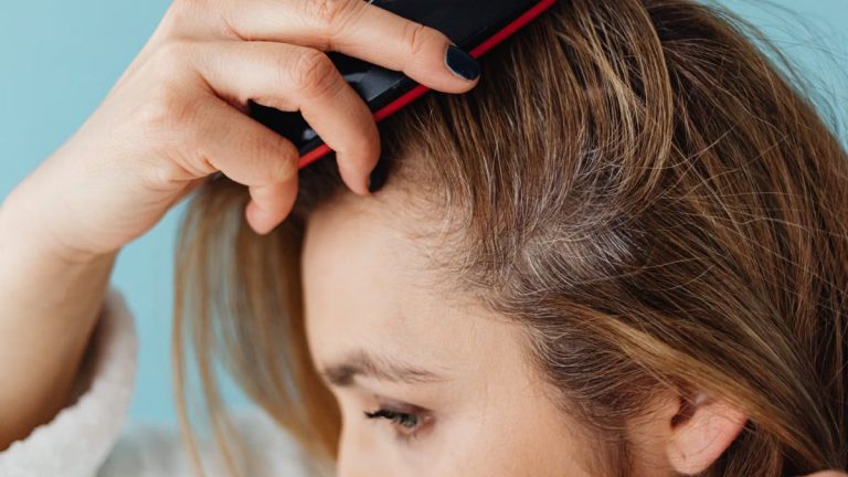 A woman brushing her hair showing hair texture and care.